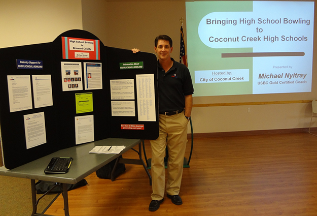 Mike Nyitray standing with display  for the City of Coconut Creek presentation on April 14, 2012