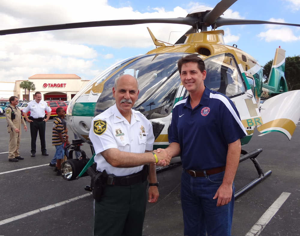 Sheriff Al Lamberti with Mike Nyitray in front of the BSO helicopter.